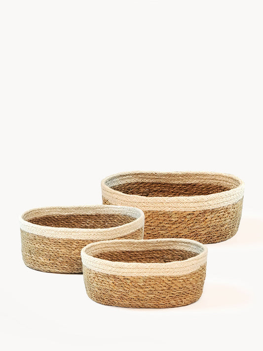Three woven baskets of different sizes on a white background