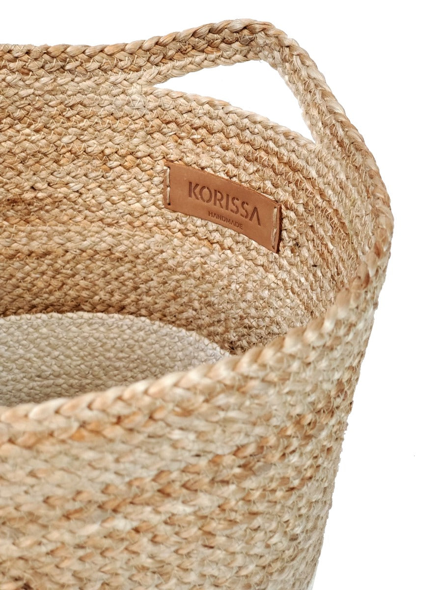 Woven basket with a visible 'Korissa' brand label on a white background