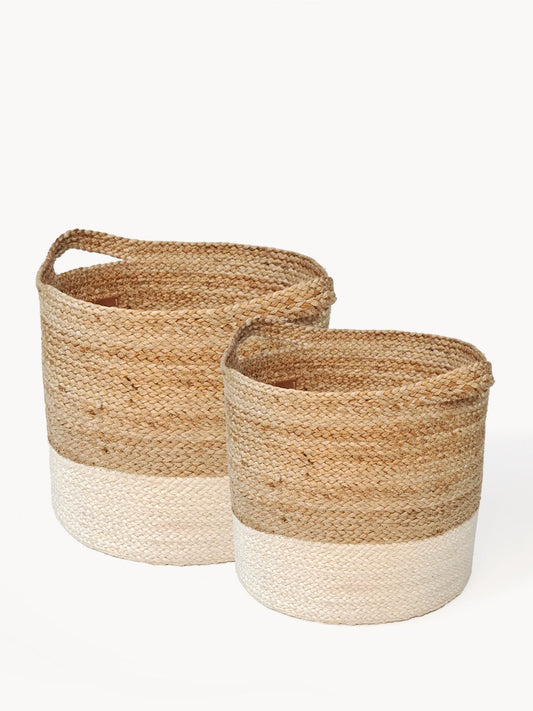 Two woven baskets with natural and white accents on a white background