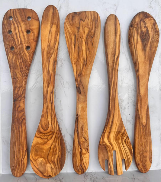 Set of five wooden utensils on a light gray background